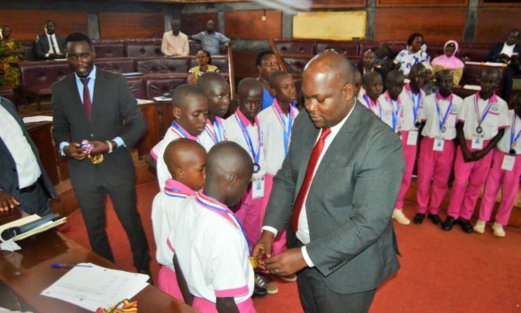 District Chairperson-Hon Kawuki Simon Peter recognizes and celebrates excellence of Mpigi Pupils with Disabilities for winning the Trophy and Gold medals at the National Paralympic Games